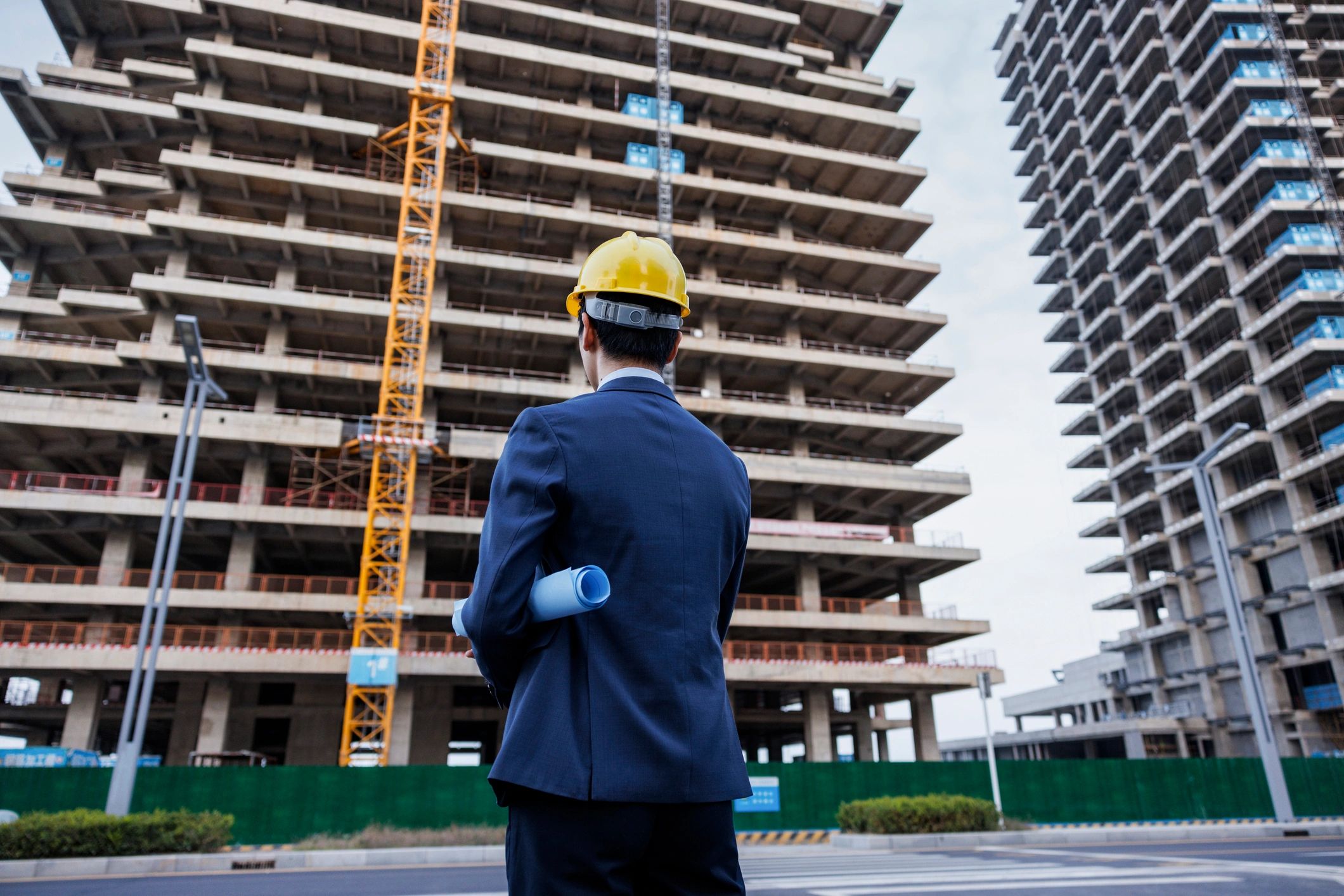 Construction site manager reviewing plans and clipboard