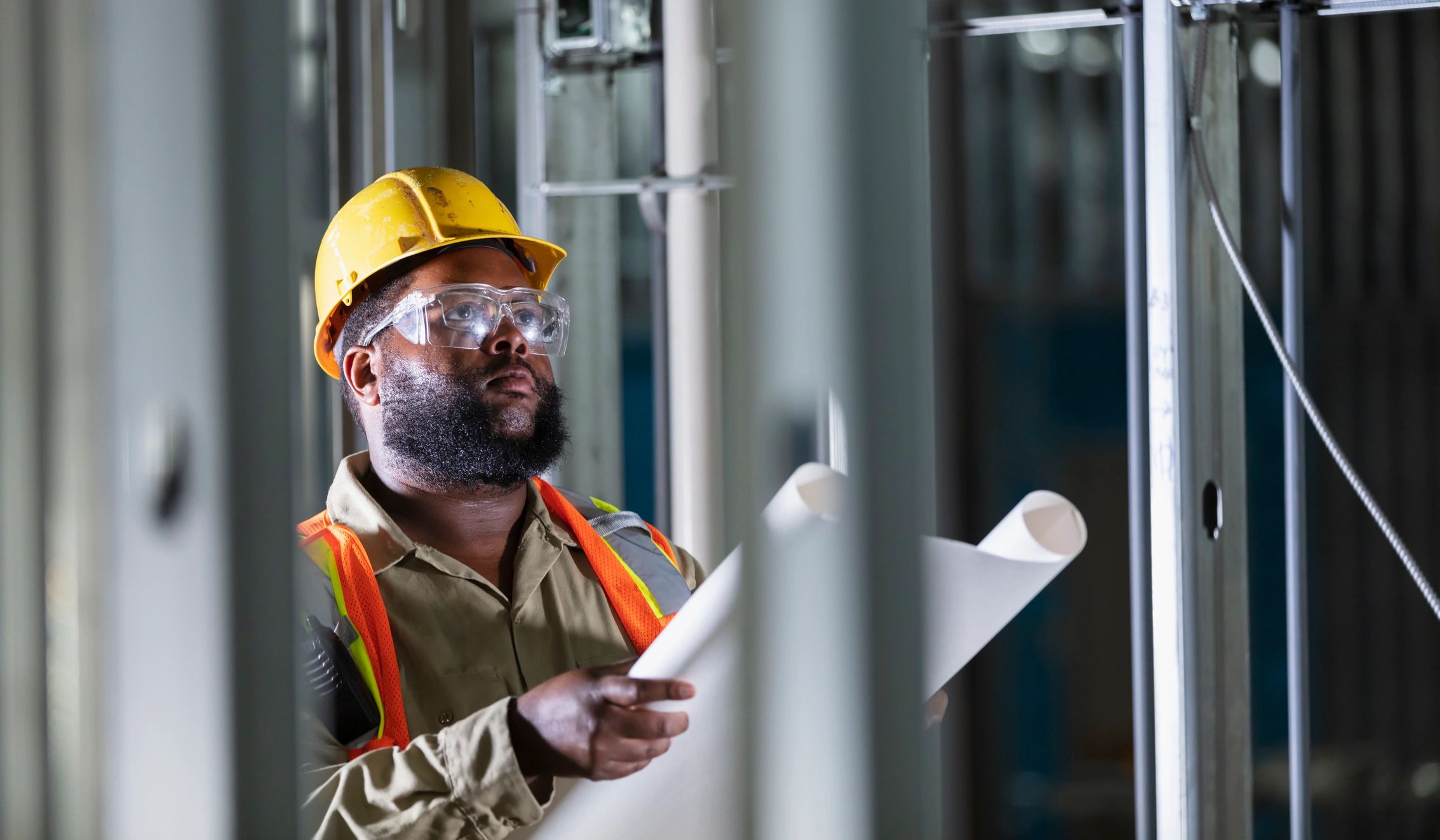 Construction professional reviewing plans on site